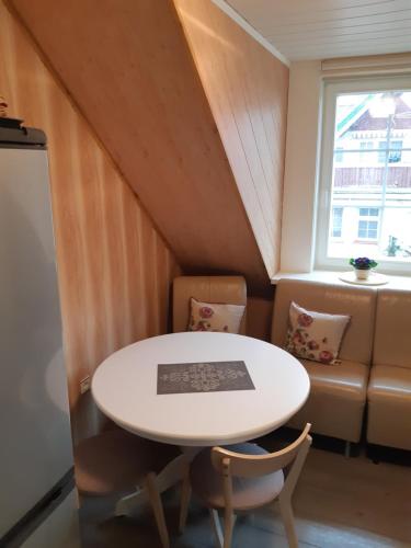 a room with a table and chairs and a couch at Lana in Nida