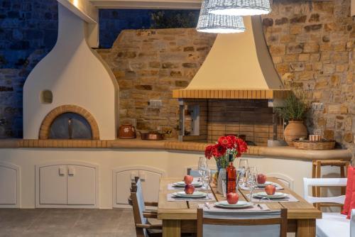 a kitchen with a table with flowers on it at Naxos Rock Villas in Stelida