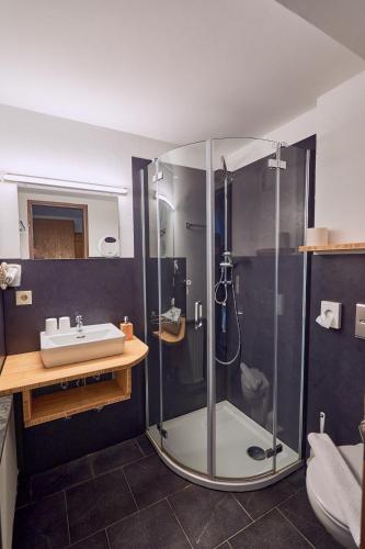 a bathroom with a shower and a sink at Landhotel Krone in Oberreute