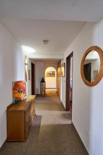 a hallway with a mirror and a dresser in a room at Landhotel Krone in Oberreute
