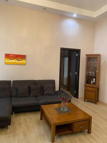 a living room with a couch and a coffee table at Beridze Apartment in Tbilisi City