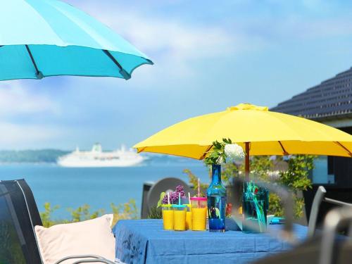 una mesa con una sombrilla amarilla y bebidas en ella en Ferienhaus Randers, en Steinbergkirche