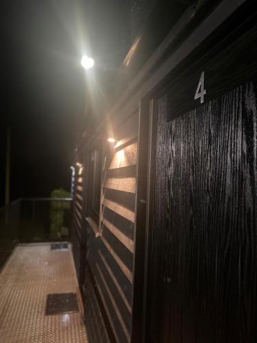 une porte en bois avec le numéro 4 la nuit dans l'établissement Comus Inn, à Selby