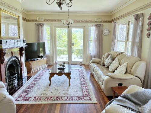 a living room with a couch and a coffee table at Serenity in Healesville