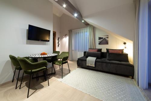 a living room with a couch and a table at Rasos Vila in Palanga