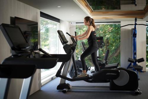 a woman riding on an exercise bike in a gym at Shama Yen-Akat Bangkok in Bangkok