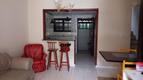 a living room with a couch and a table and chairs at Saquarema - Condomínio Residencial Iate hotel. in Saquarema