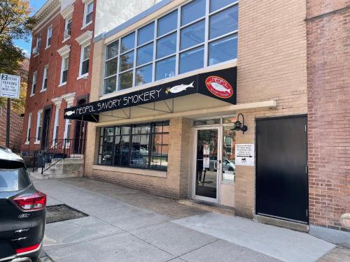a brick building with a sign for a dog shop at Downtown Home - Close to Topgolf, Ravens Stadium, Orioles Park, UM Baltimore in Baltimore