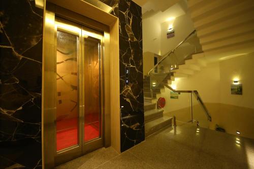 a hallway with a glass door and a staircase at Hotel Dream Inn in Rishīkesh