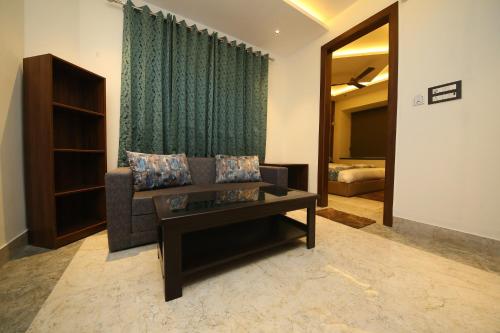 a living room with a couch and a table at Hotel Dream Inn in Rishīkesh