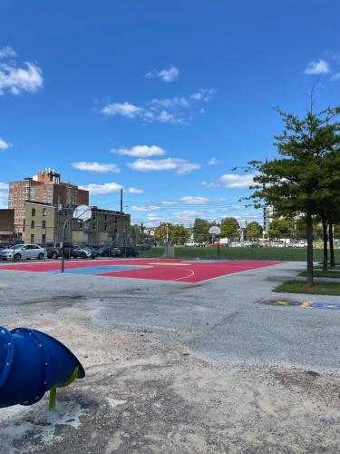an empty basketball court in a parking lot at Downtown Home - Close to Topgolf, Ravens Stadium, Orioles Park, UM Baltimore in Baltimore