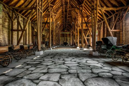 a large room with a large stone floor in a building with many carts at Kadyny Folwark Hotel & SPA in Kadyny