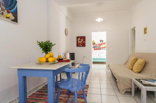 a living room with a blue table and a blue chair at Armenaki Apartment at the center of Zakynthos Town in Zakynthos