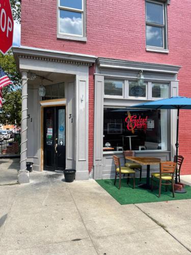 a restaurant with a table and chairs in front of a building at Downtown Home - Close to Topgolf, Ravens Stadium, Orioles Park, UM Baltimore in Baltimore
