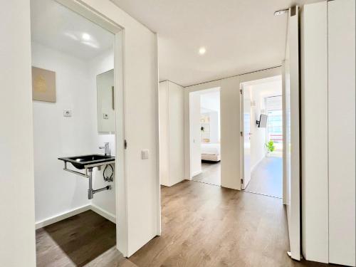 a hallway with white walls and wooden flooring in a apartment at Home Out Vilamoura 20 Levante in Vilamoura