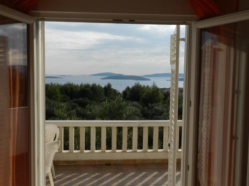 a balcony with a view of the water at Apartments Senny in Orebić