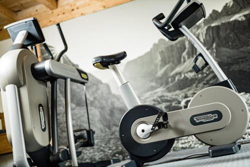 a gym with two exercise bikes in a room at Boutique & Fashion Hotel Maciaconi - Gardenahotels in Santa Cristina in Val Gardena