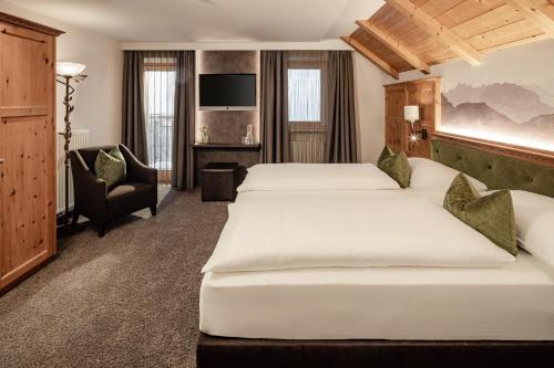 Ένα ή περισσότερα κρεβάτια σε δωμάτιο στο Boutique & Fashion Hotel Maciaconi - Gardenahotels
