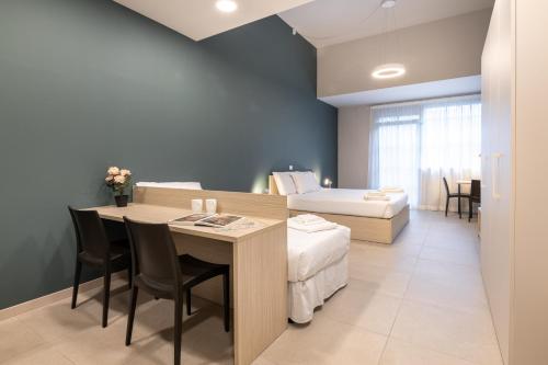 a room with a bed and a table with chairs at Camplus Regio Parco in Turin