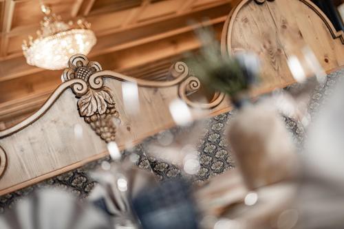 a chandelier with a crown hanging from a ceiling at Romantik & Family Hotel Gardenia***S in Selva di Val Gardena