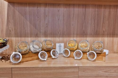 a bunch of bowls of food on a shelf at Transamerica Executive Jardins in Sao Paulo