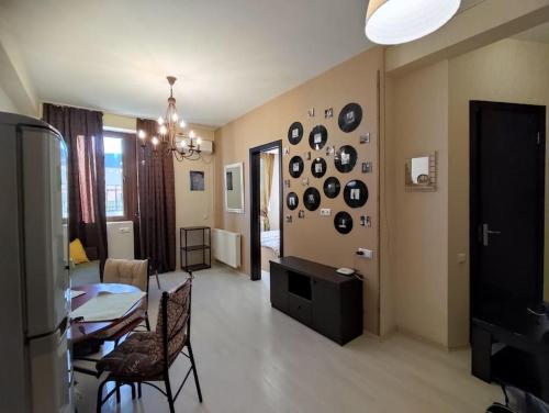 a living room with a table and a dining room at Уютная и светлая квартира с видом на горы in Tbilisi City