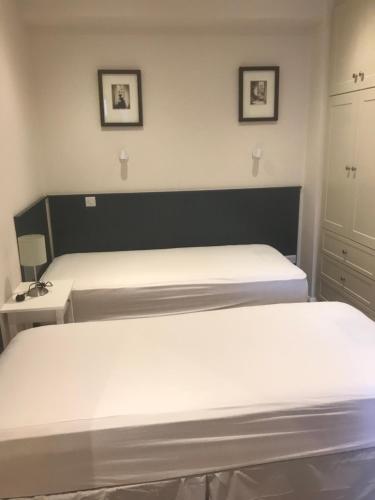 two beds in a small room with two beds at Eyre Luxury Apartment in Galway