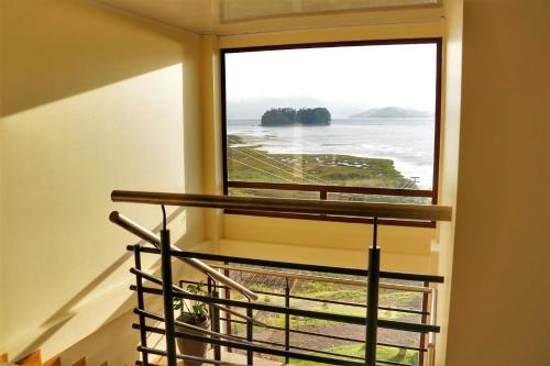 a room with a window with a view of the ocean at Hotel Rocamonti in Aquitania