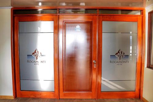 a wooden elevator in a building with two glass doors at Hotel Rocamonti in Aquitania