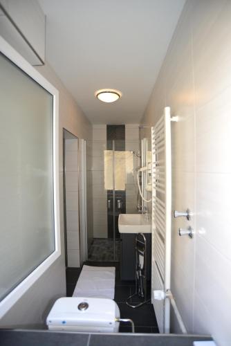 a small bathroom with a sink and a toilet at Landhotel Kussmann in Wrexen