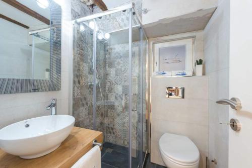 a bathroom with a sink and a shower and a toilet at New Apartment La Barca Old Town in Dubrovnik