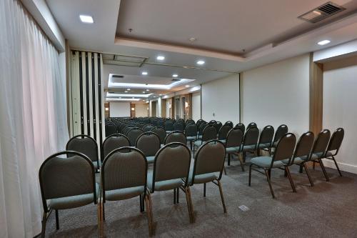 a row of chairs in a conference room at Transamerica Executive Jardins in Sao Paulo