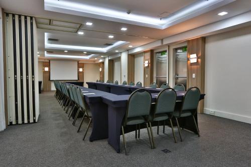 a conference room with a long table and chairs at Transamerica Executive Jardins in Sao Paulo