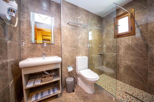 a bathroom with a toilet and a sink and a shower at Hotel Vista Mare in Ksamil