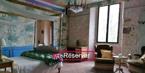 a bedroom with a bed and a chair at Hôtellerie Jardiniers Gourmands in Morsains