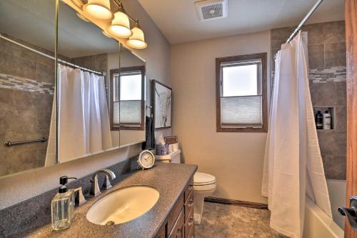 a bathroom with a sink and a toilet and a mirror at Charming Joliet Ranch House on a Working Farm in Silesia