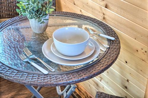 a glass table with a cup of coffee on it at Sunny Catfish Cabin with Views of Toledo Bend in Alliance