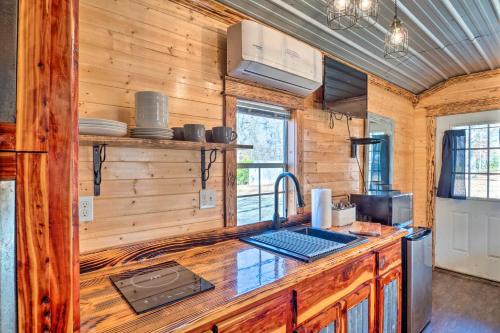 a kitchen with wooden walls and a wooden counter top at Sunny Catfish Cabin with Views of Toledo Bend in Alliance