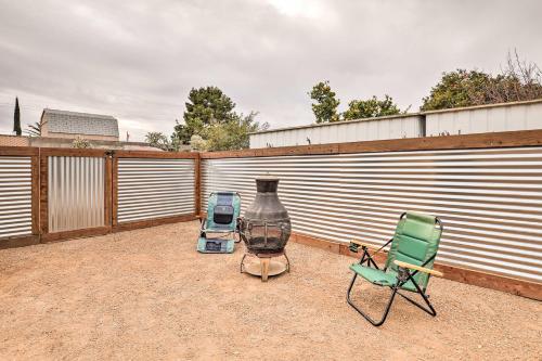 a patio with two chairs and a vase next to a fence at Sunny Tucson Abode with Fire Pit 9 Mi to U of A in Tucson