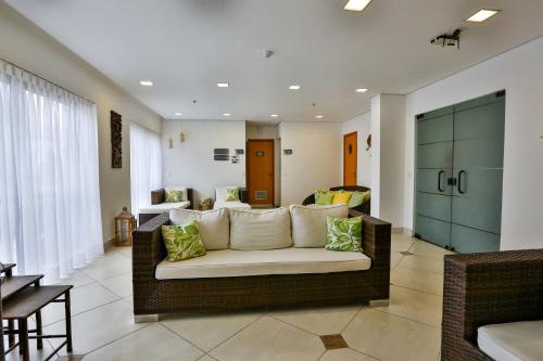 a living room with a couch and a table at Transamerica Executive Jardins in Sao Paulo