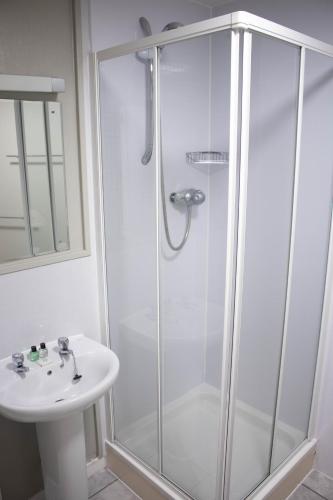 a bathroom with a shower and a sink at The Rosedale Hotel & Restaurant in Portree