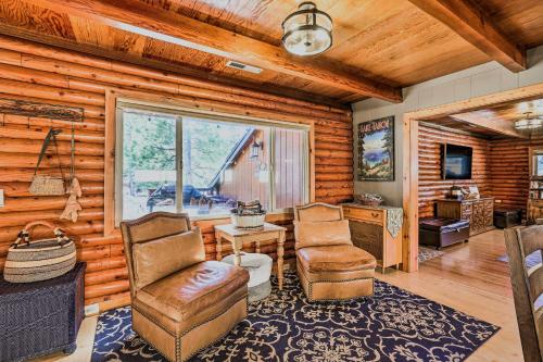a living room with two chairs and a table at Dog-Friendly Kings Beach Log Cabin with Hot Tub! in Kings Beach