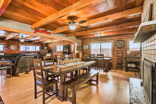 a dining room with a table and wooden ceilings at Dog-Friendly Kings Beach Log Cabin with Hot Tub! in Kings Beach