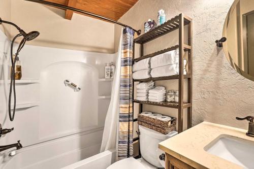 a bathroom with a shower and a toilet and a sink at Dog-Friendly Kings Beach Log Cabin with Hot Tub! in Kings Beach