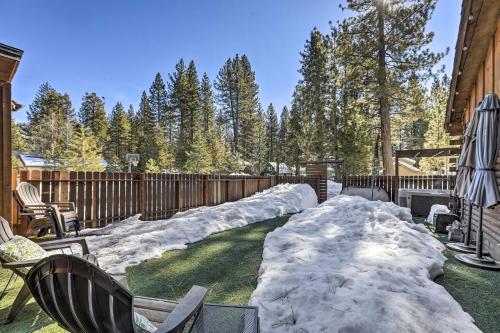 a yard covered in snow next to a fence at Dog-Friendly Kings Beach Log Cabin with Hot Tub! in Kings Beach
