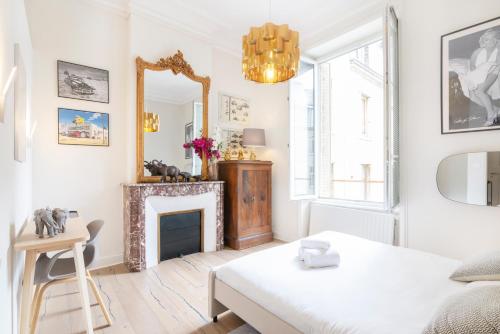 un salon avec une cheminée et un miroir dans l'établissement Le Palais de Saint-Jean, à Nancy