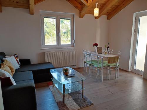 a living room with a couch and a table at Apartments Pulic in Skradin