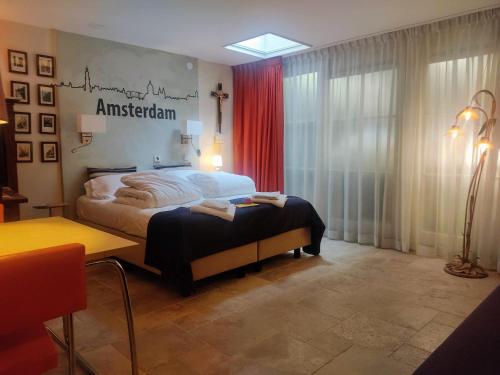 a bedroom with a bed with a sign on the wall at Studio53Amsterdam in Amsterdam