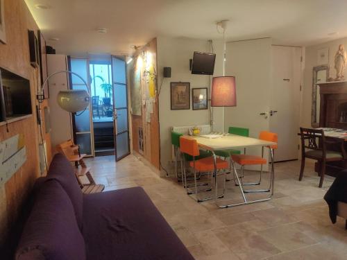 a living room with a couch and a table and chairs at Studio53Amsterdam in Amsterdam