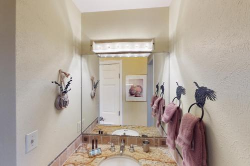a bathroom with a sink and a large mirror at Quaint Mountain Condo in Frisco